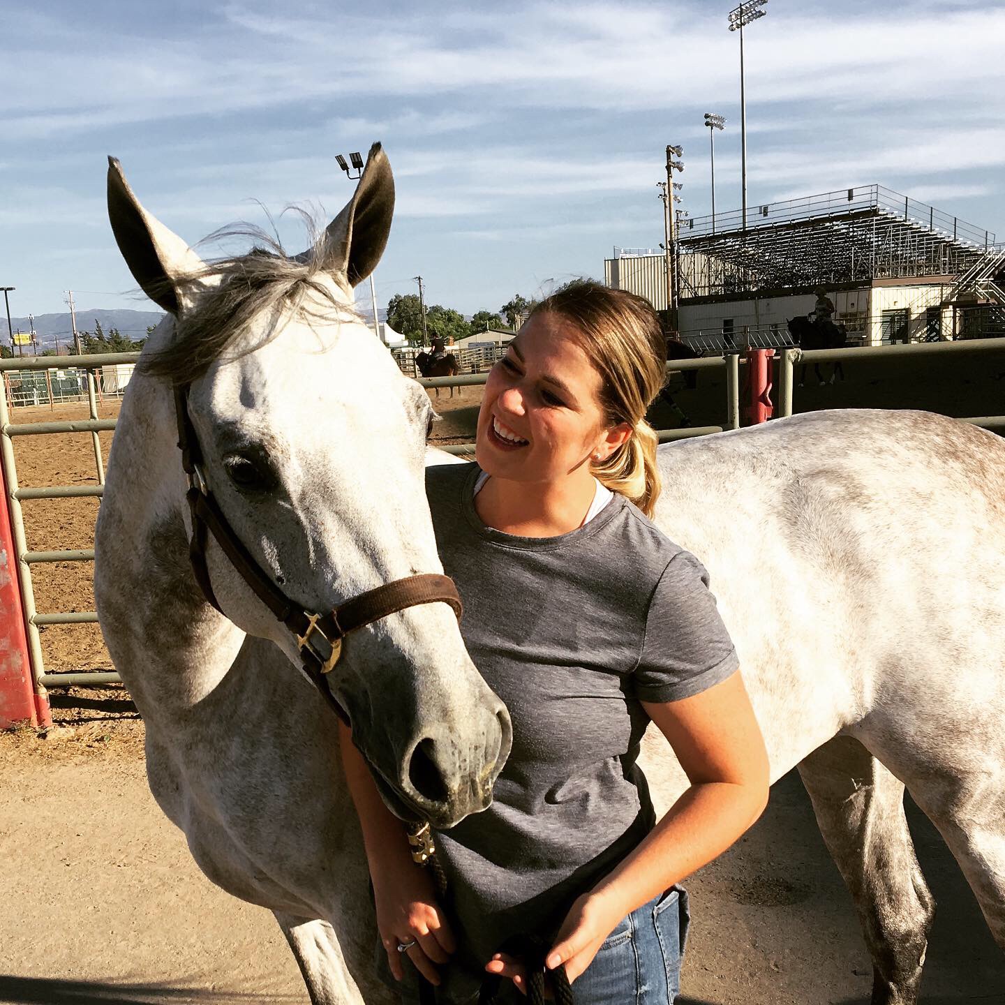 Dr. Beverly Strunk smiling beside her horse